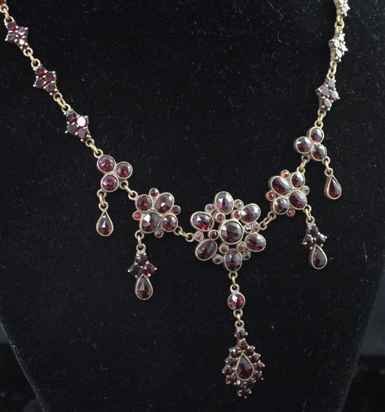 A Victorian gilt metal and garnet drop necklace, 19in.